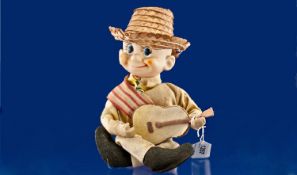 Small Musical Automaton Guitar Player, seated `googly-eyed` boy with straw hat, felt guitar and