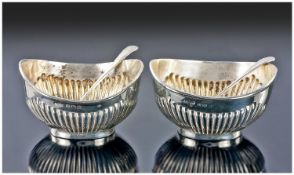 Edwardian pair of Silver salts with ribbed bodies and matching spoons. Hallmark Birmingham 1910.