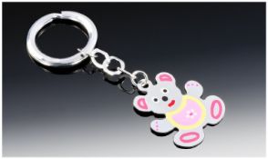 A Silver & Enamel Novelty Teddy Bear Key Ring. The bear enamelled in red, pink, yellow, black &