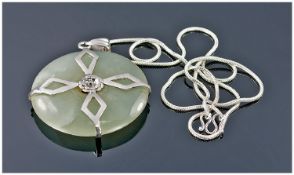 A Circular Jade and Cross Banded Silver Overlay Pendant, Supported on a Silver Chain. Jade pendant