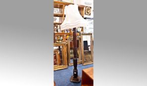 Mahogany Effect Standard Lamp, fitted with cream shade, shaped column, raised on a stepped base,