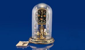Louis Philippe Anniversary Clock, with glass dome, the face in black with brass Arabic numerals,