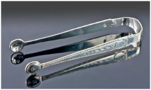 Pair of Georgian silver tongs by Charles Hougham circa 1780. Very fine quality with bright cut