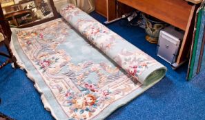 Large Oriental Style Woolen Rug, decorated with stylised floral patterning on a green ground,