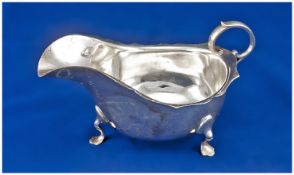 A large silver gravy boat with c scroll handle supported on hoofed feet. Chester marks for 1917. 7.