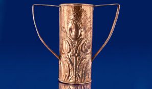 An Arts and Crafts Embossed Copper Vase with shaped handles of unusual form in the style of the