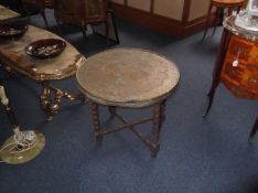 Small Brass Topped Occasional Table, the brass Oriental embossed top raised on a collapsible barley