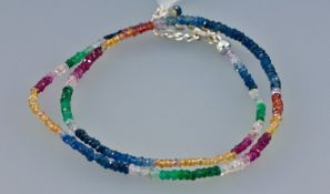 Emerald, Ruby and Sapphire Faceted Bead Necklace, the centre front with deep blue sapphires