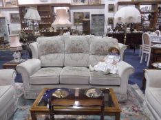 Four Piece Traditional Beige Suite, comprising three seater settee, two winged armchairs and a
