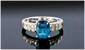 9ct white gold set single stone London topaz and diamond ring. The emerald cut London topaz of good