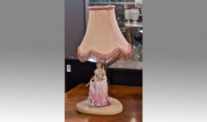 Mid 20th Century Table Lamp, with a figure of a lady attached to plinth, fitted with pink shade, 16