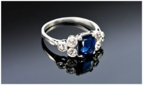 18ct White Gold Sapphire And Diamond Ring, Set With A Central Cushion Cut Sapphire Set Between Six
