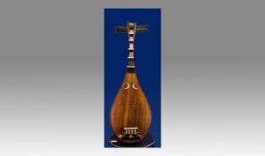 A Fine Japanese Biwa On Stand. The Biwa is a Japanese short-necked fretted lute, often used in