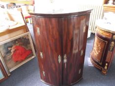 George III Mahogany Hanging Corner Cupboard, circa 1780, of bow-fronted form, with concave moulded