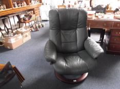 Contemporary Green Leather Swivelling Recliner Chair, raised on a veneered circular base, with a