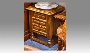 Small Oak Bedside Cabinet, fitted with three drawers, raised on turned legs, joined by square