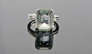 White Metal Gem Set Ring, Set With A Very Light Blue Emerald Cut Stone (Paper Wear To Most Of