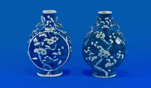 Two Nineteenth Century Chinese Blue and White Prunus Flowers decorated Moon Flasks, 9 inches in