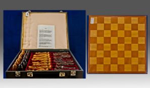 Carved Wood Chess Set. In fitted case, together with an inlaid chess board.