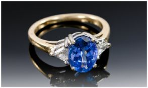 18ct Gold Tanzanite And Diamond Ring, Central Oval Tanzanite (9.14 x 7.12 x 4.78mm) Set Between Two