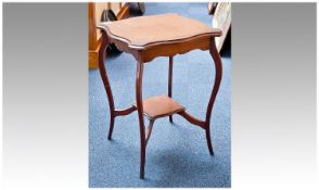 Edwardian Mahogany Two Tier Occasional Table, the top of serpentine form, raised on French cabriole