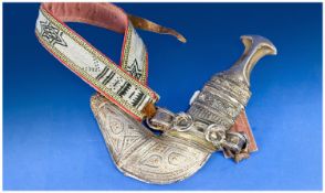 20th Century Arab Jambiya with silver and gold inlay, horn grip and decorated belt.