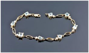 9ct Gold Bracelet Set With Different Fancy Cut Blue Topaz And Small Diamond Chips. Length 7¼