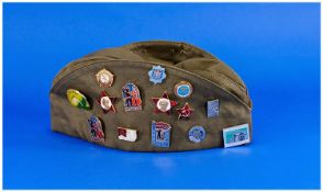 Russian Canvas Cap, Together With A Collection Of Badges,