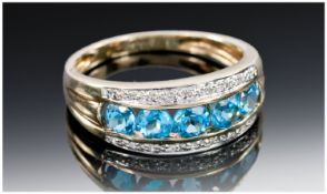 9ct Gold Dress Ring, Set With A Central Row Of Five Blue Zircon Coloured Faceted Stones Between Two
