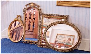 Collection of Four Mirrors, comprising oval mirror with decorative laurel leaf motif, another