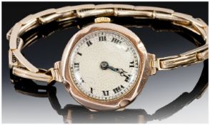 Ladies 1920`s 9ct Gold Cased Maual Wind Wristwatch, supported on a 9ct gold expanding bracelet.