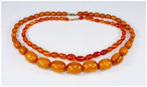 Amber Coloured Necklaces, 22 inches and 17.5 inches long, early - mid 20th century, total weight
