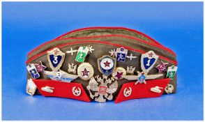 Russian 20th Century Military Hat, loaded with 25 badges, various subjects.