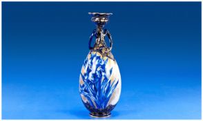 Royal Doulton Blue, White and Gilt Ovoid Vase, decorated to front and back with sprays of iris, the