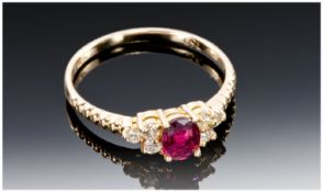 18ct Gold Ruby Ring Set With A Central Ruby Between Six Diamonds. Stamped 750, Ring Size L