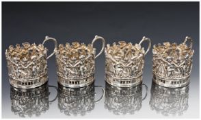 Set Of Four Silver Holders For Liqueur Glasses, Of Pierced Form With A Continuous Row Of Putti. All