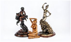 Two Resin Figures, one of a dancing Flemenco lady, raised on a wooden base, measuring 14 inches