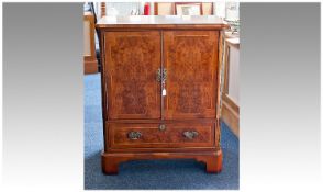 Burr Yew Veneered T.V Cabinet, fitted with two doors opening to reveal TV section, fold down