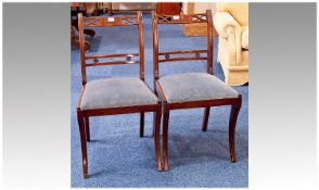 Pair of Mahogany Side Chairs, raised on sabre legs, measuring 34 inches high.