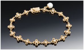 9ct Gold Fancy Link Bracelet, Each Link Set With A Central Round Cut Diamond, Single Pearl Charm.