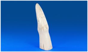 An Inuit Style Carved Ivory Tusk, with an elongated face carved to the centre, with round stained
