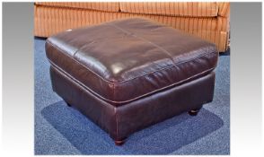 Contemporary Brown Leather Pouffe, of square form, raised on turned wooden feet.