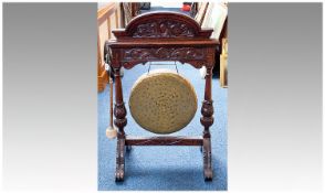 An Impressive Late Victorian Carved Oak Hall Dinner Gong. The brass gong supported by tapering