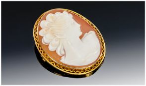 9ct Gold Framed Cameo. A bust of a young lady within a pierced non openwork oval mount with 9ct
