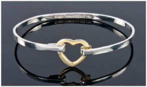 Silver & Gold Coloured Bangle With Heart Shaped Clasp, Marked To The Interior 2003 Tiffany & Co .