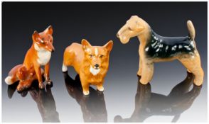 Three Beswick Animal Figures, comprising a sitting fox, with a white tail tip, Corgi variation,