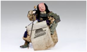 Japanese Kneeling Samurai Small Doll Figure, holding a banner and wearing black lacquered body