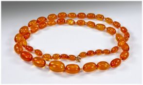 Amber Coloured Bead Necklace, Of Graduating Form, Length 35 Inches, Weight 68 Grammes.