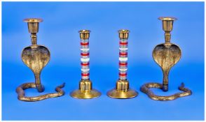 Two Pairs of Twentieth Century Candlesticks comprising one Oriental pair of cobra form with sinuous