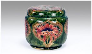 Macintyre Circular Lidded Jar `Cornflower` unusual pink colouring. Circa 1910. WHC to base. 5`` in